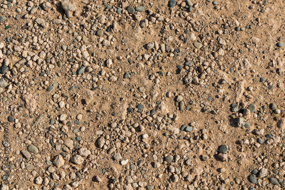 Gravel road texture. Sandy background with stones Gravel road texture. Sandy background with stones