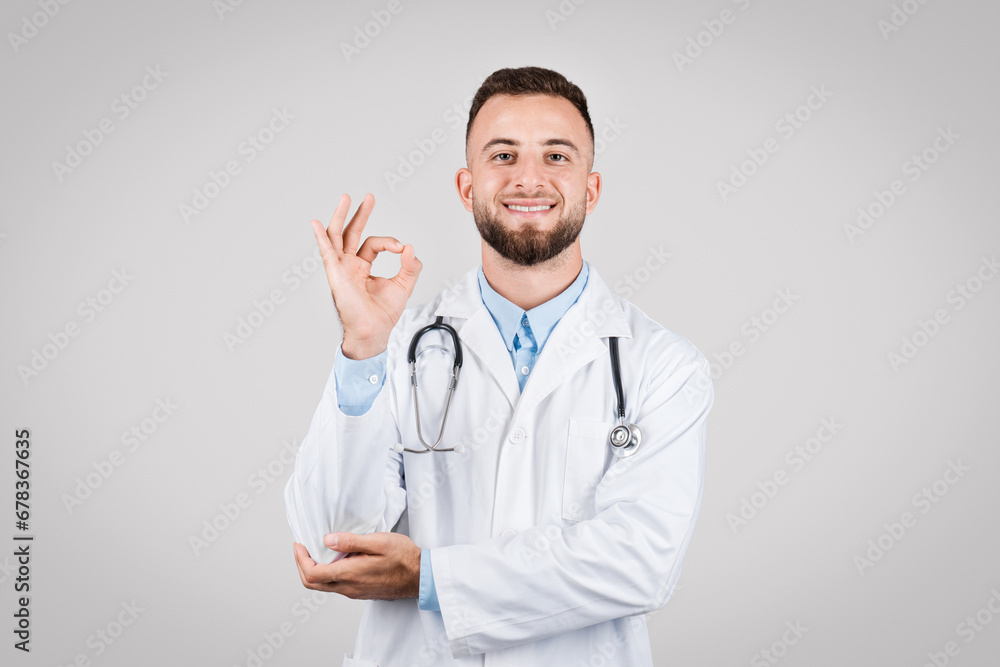 Smiling man doctor making okay sign Smiling man doctor making okay sign