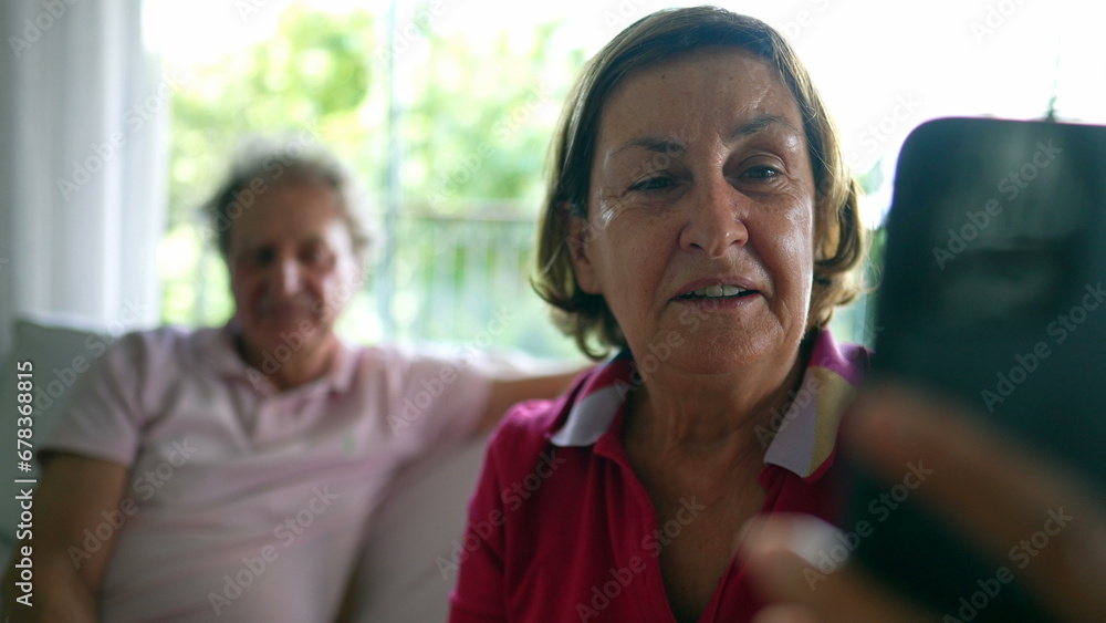 Elderly Woman Engages in Video Call - Connecting with Distant Family, Grandmother Bridging Distances with Smartphone Video Chat, Conversing with relatives Elderly Woman Engages in Video Call - Connecting with Distant Family, Grandmother Bridging Distances with Smartphone Video Chat, Conversing with relatives
