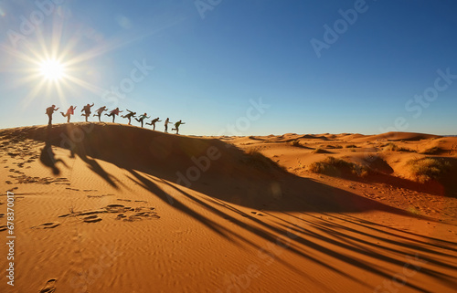 Sahara Silhouettes: Joyful Tourists Capture Moments in the Desert Sun