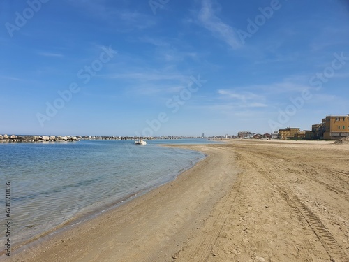 Endless long beach in Rimini  Italy with blue sky