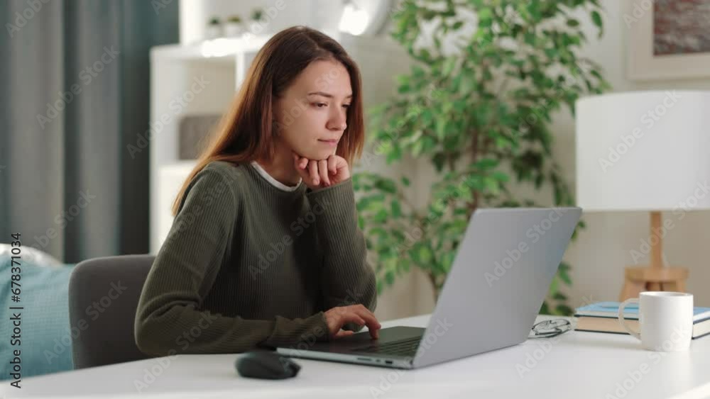 Cheerful woman checks mails in morning, enters tasks for remote work at home at light table in laptop, messages with colleagues before work Cheerful woman checks mails in morning, enters tasks for remote work at home at light table in laptop, messages with colleagues before work