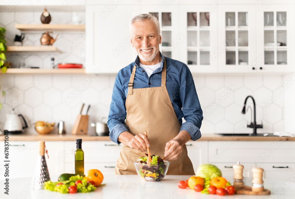 Portrait Of Handsome Mature Chef Man In Apron Posing In Kitchen Interior Portrait Of Handsome Mature Chef Man In Apron Posing In Kitchen Interior