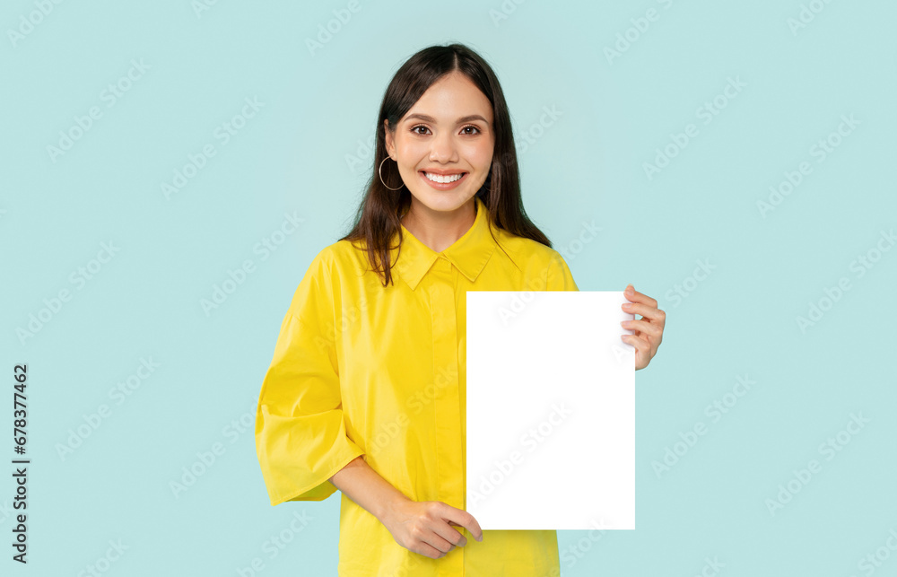 Positive millennial woman showing vertical blank placard Positive millennial woman showing vertical blank placard