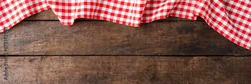 Checkered tablecloth on wooden background with copyspace