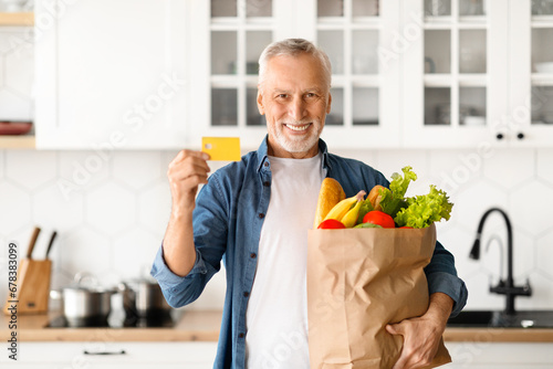 Happy Senior Man Holding Credit Card And Paper Bag With Groceries