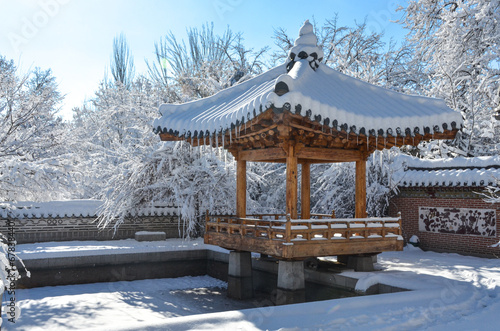 snow covered traditional Korean style pavilion in Seoul National park during winter season (Tashkent, Uzbekistan) © ssmalomuzh