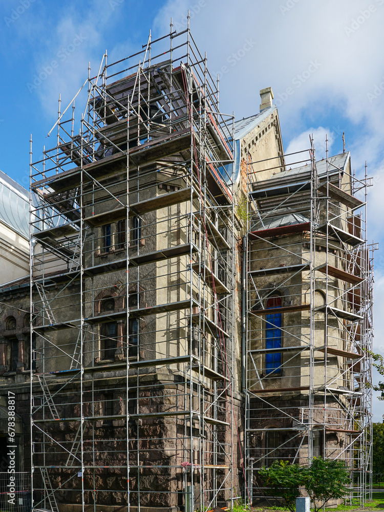 Repair of the facade and roof of an old Lutheran stone church using complicated shaped scaffolding Repair of the facade and roof of an old Lutheran stone church using complicated shaped scaffolding