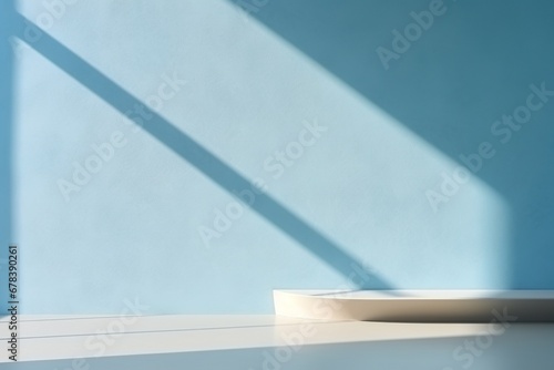 Minimal light blue background for product presentation. Shadow and light from windows on wall.