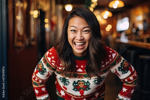 Smiling asian woman in ugly Christmas sweater.