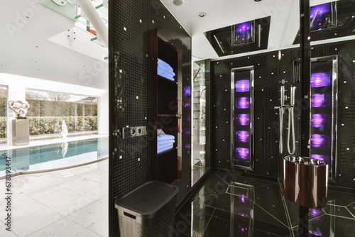 Large black steam room and swimming pool photo