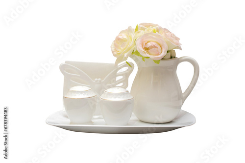 Still life with a decorative pitcher with flowers, pepper shaker, salt shaker and napkin isolated