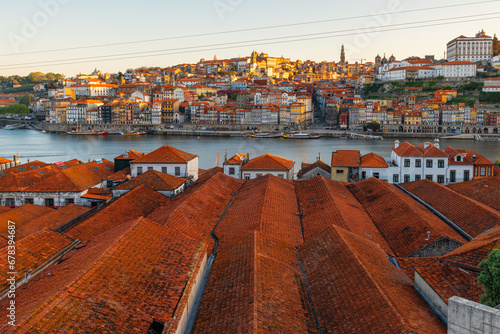 Porto, Portugal old town on the Douro River with orange rooftops of Vila Nova de Gaia buildings at sunrise. Medieval architecture of Oporto downtown. Travel destination