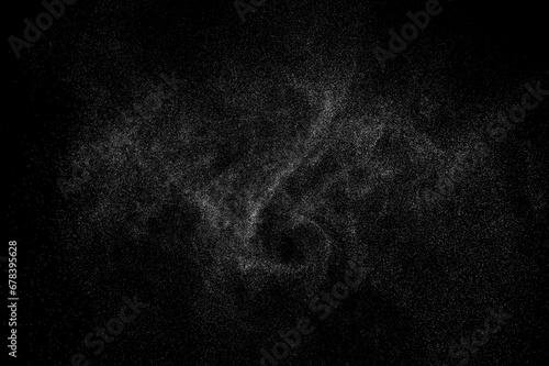 Water spray with droplets and particles on black background