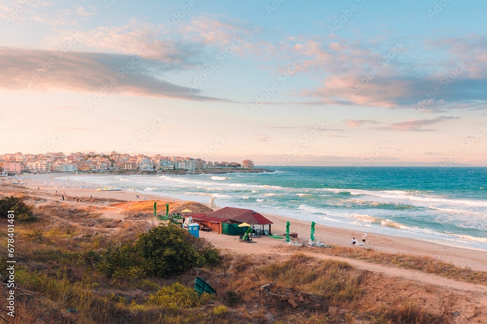 Beautiful view of a beach with a wavy sea during sunrise Beautiful view of a beach with a wavy sea during sunrise