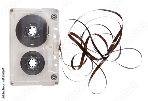 Old cassette tape unrolled on an isolated background.