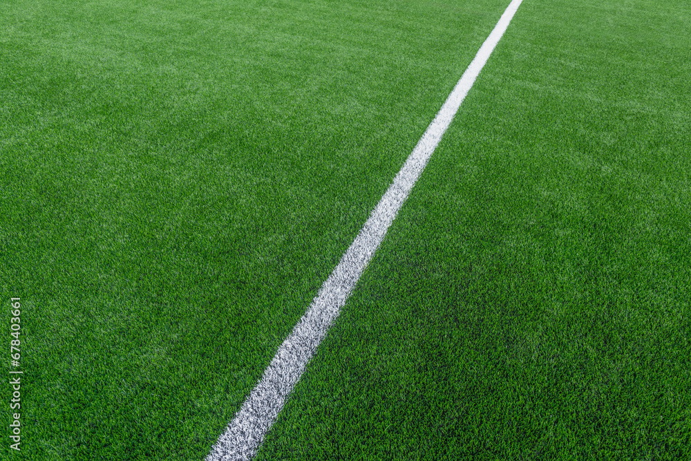 Green synthetic grass sports field with white line shot from above. Soccer, hurling, lacrosse, rugby, football, baseball sport concept