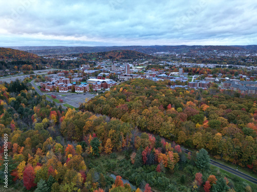 arial view of binghamton university in vestal, new york during autumn with fall foliage (leaves changing colors) at dusk, sunset, cloudy sky (library tower, student union, mountainview residence hall) photo