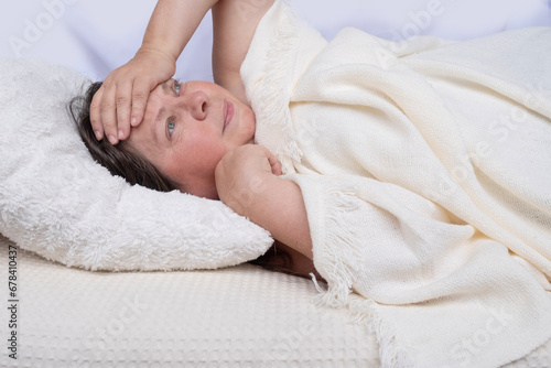 woman 45 years old can't fall asleep covered with white blanket, experiencing insomnia, Insomnia Management concept, Sleep disturbances in menopause