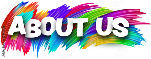 About us paper word sign with colorful spectrum paint brush strokes over white.