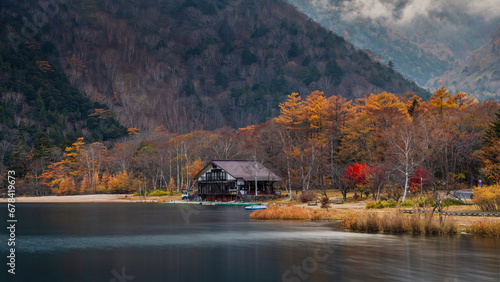 Cabin House by Lake and Mountains in Autumn photo