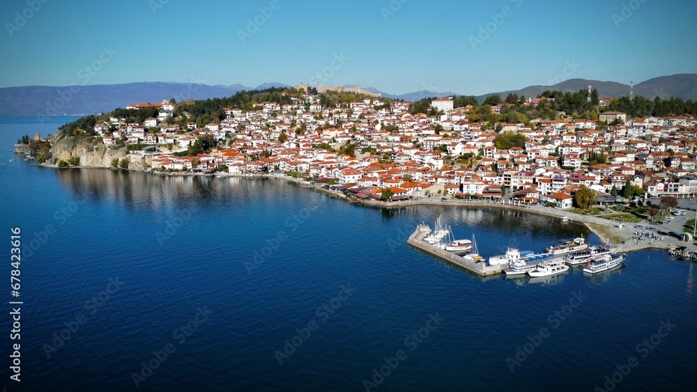 Aerial view of the Ohrid cityscape on the lakeshore against a blue sky, in the Republic of Macedonia