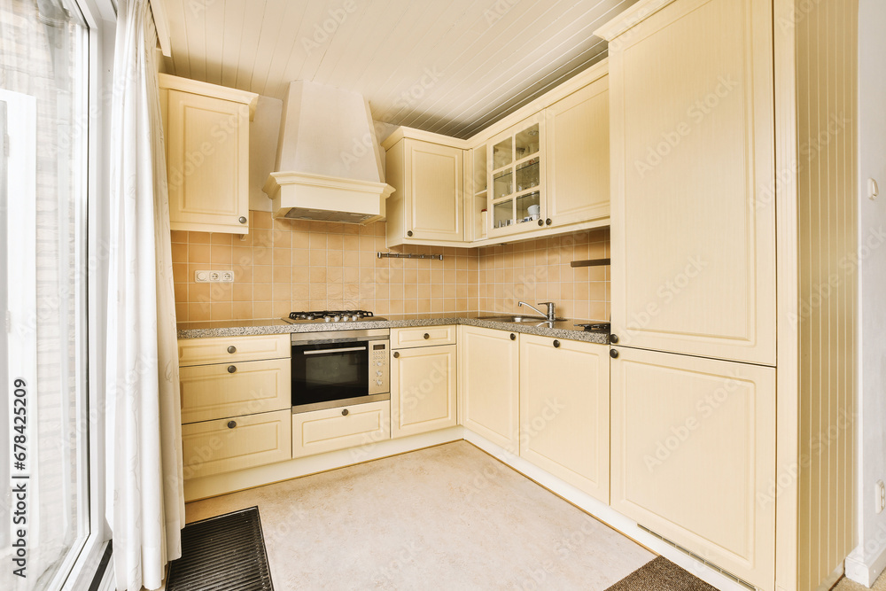 Kitchen with ivory cabinets and appliances by window Kitchen with ivory cabinets and appliances by window