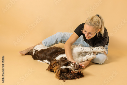 Owner and dog studio portrait. 
Cute curly hair dog and her owner studio portrait.
 photo