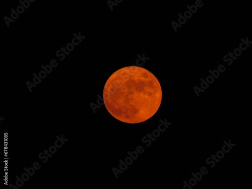 Red full moon on a black background