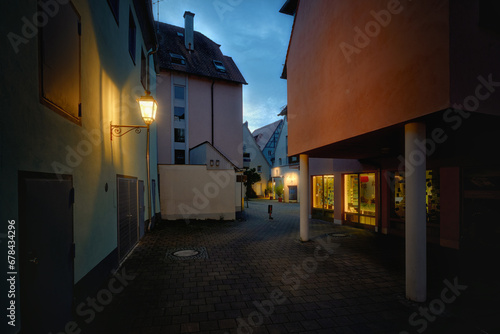 A night street in an old German town with colourful houses and a street lamp on the wall. Ansbach  Bavaria Region Middle Franconia  Germany