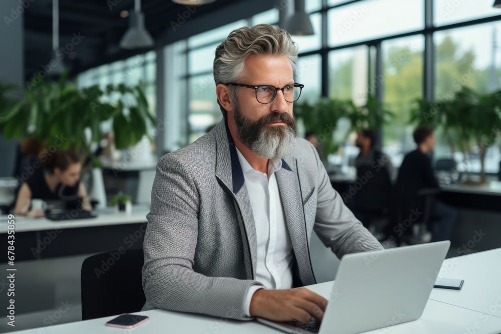 Dedicated elderly man wearing stylish eyeglasses focused on laptop tasks with utmost dedication Dedicated elderly man wearing stylish eyeglasses focused on laptop tasks with utmost dedication