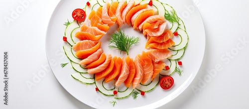 Red fish on white plate with vegetables and slivers around