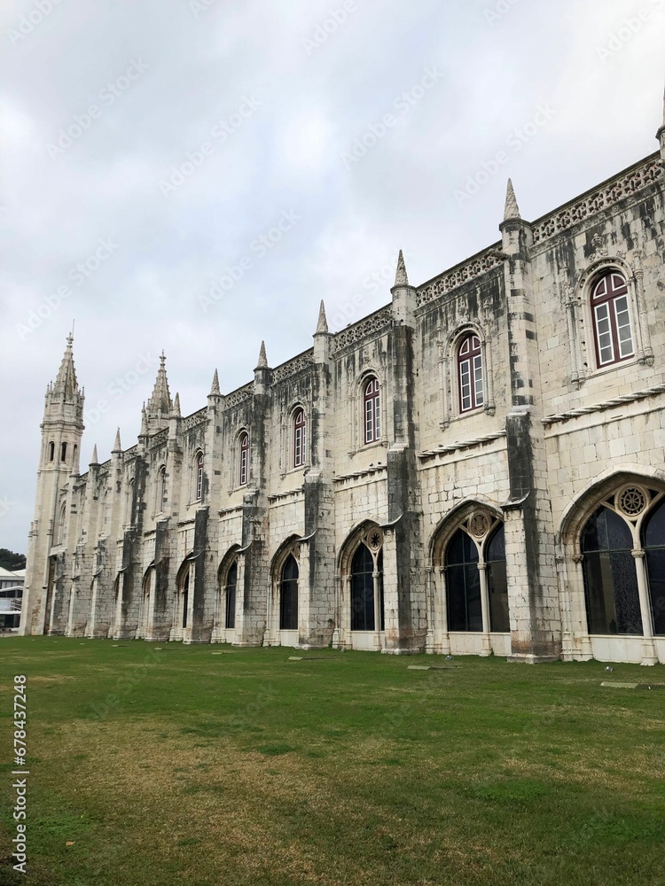 Vertical shot of the medieval Jeronimos Monastery in Portugal against the cloudy sky