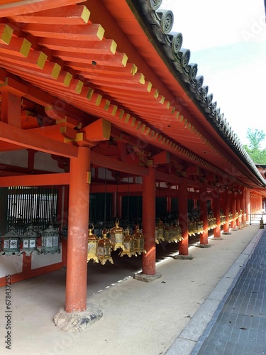 Vertical shot of a traditional Shinto temple in red tones in Japan on a sunny day