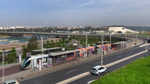 Modern tram passing by the Bou Regreg river with a view over the Grand Theatre of Rabat in Morocco