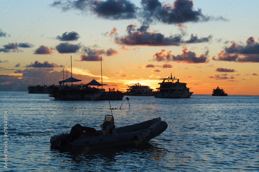 Fototapeta premium Attractive sunset with beautiful and colorful boat