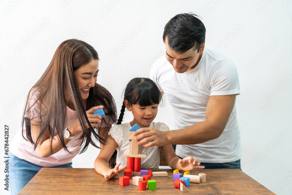 Portrait of enjoy happy love asian family father and mother with little asian girl smiling activity learn and skill brain training play with toy build wooden blocks board education game at home Portrait of enjoy happy love asian family father and mother with little asian girl smiling activity learn and skill brain training play with toy build wooden blocks board education game at home