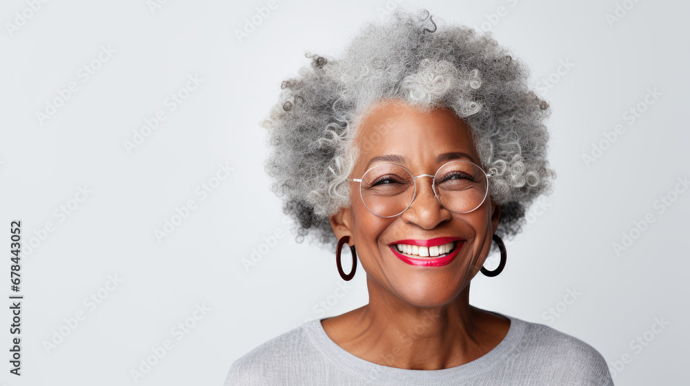 A close-up studio portrait captures the grace of a senior African American woman with grey hair, isolated on a white background, showcasing her timeless beauty.