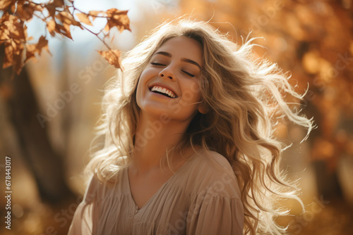 A blonde woman breathes calmly looking up enjoying autumn air