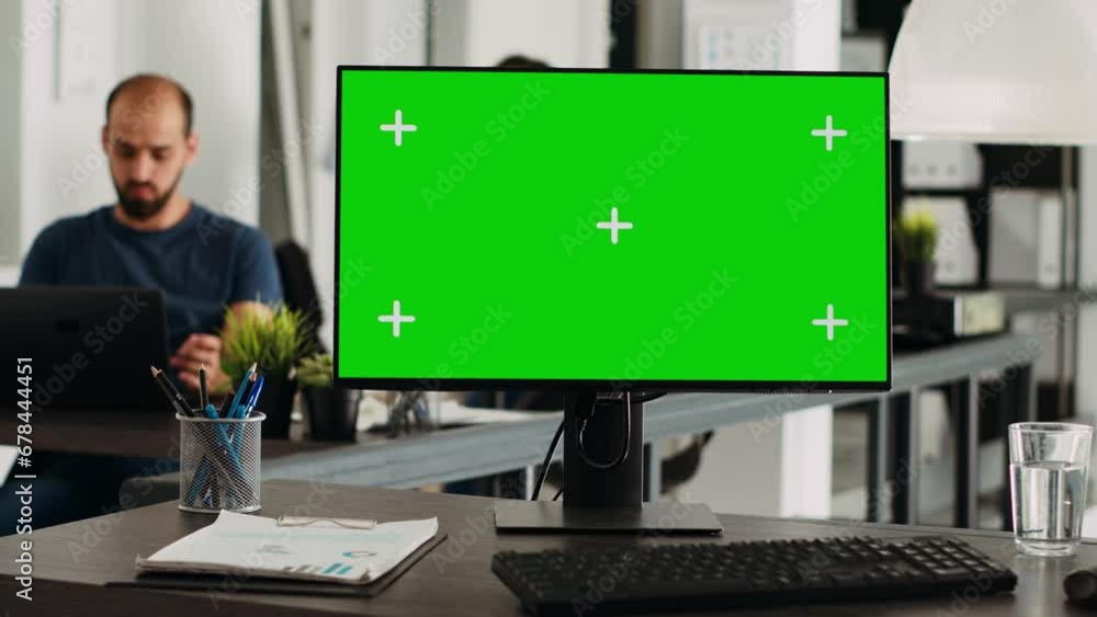 Greenscreen on computer desktop at empty workstation. PC with isolated mockup template and chromakey app running in open floor plan agency workplace, blank display copyspace technology. Greenscreen on computer desktop at empty workstation. PC with isolated mockup template and chromakey app running in open floor plan agency workplace, blank display copyspace technology.