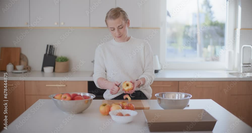 Woman Peels Apples In Kitchen Woman Peels Apples In Kitchen