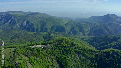 Aerial panoramic shot of green mountain range of Rhodope Mountains and holy Krastova Gora photo