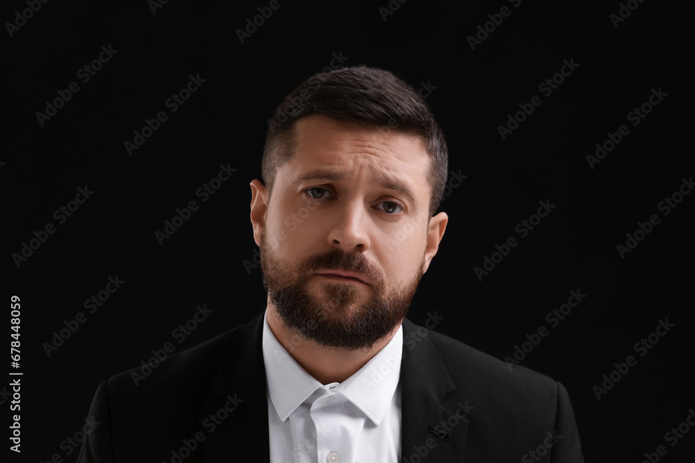 Personality concept. Sad man on black background Personality concept. Sad man on black background
