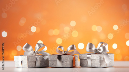 Silver gift presents on a light orange background with colorful bokeh and stars glittering