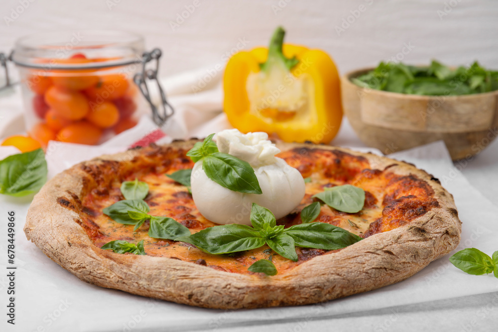 Delicious pizza with burrata cheese and basil on table, closeup Delicious pizza with burrata cheese and basil on table, closeup