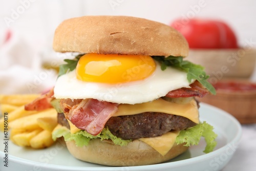 Delicious burger with fried egg served on table, closeup