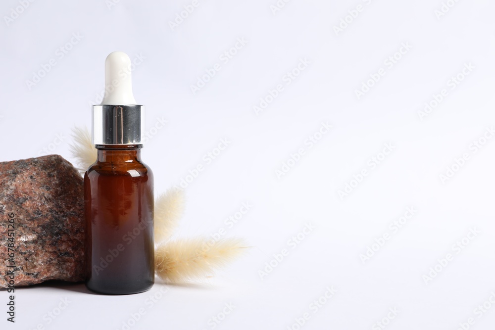Fototapeta premium Composition with bottle of cosmetic serum on white background. Space for text