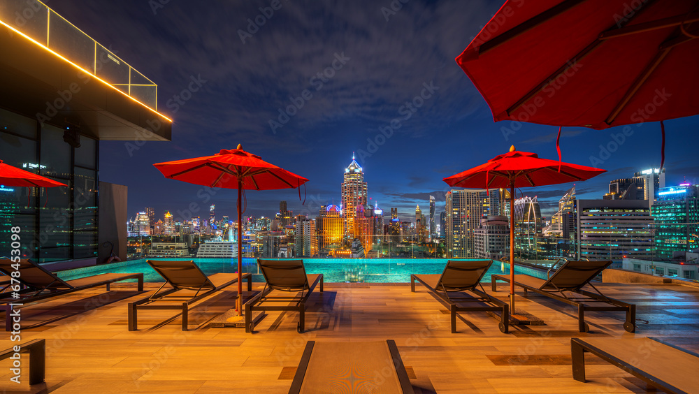 swimming pool and roof top bar on hotel deck in Bangkok city