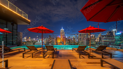 swimming pool and roof top bar on hotel deck in Bangkok city