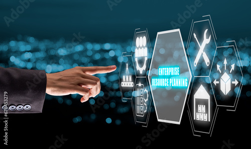 Enterprise resource planning concept, Business person hand touching enterprise resource planning icon on virtual screen. photo